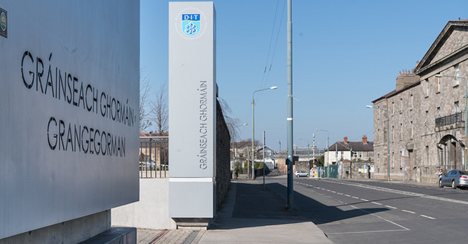 A view down a street in Dublin with the entrance to DIT Grangegorman on the left 