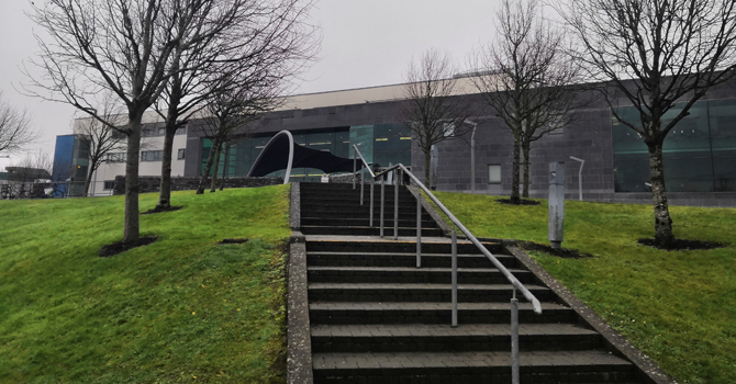 a staircase and grass on the grounds of GMIT