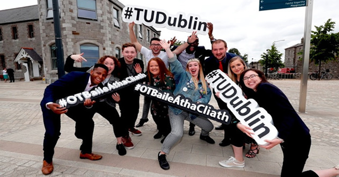 Students from TU Dublin posing for photo with signs reading #TUDublin