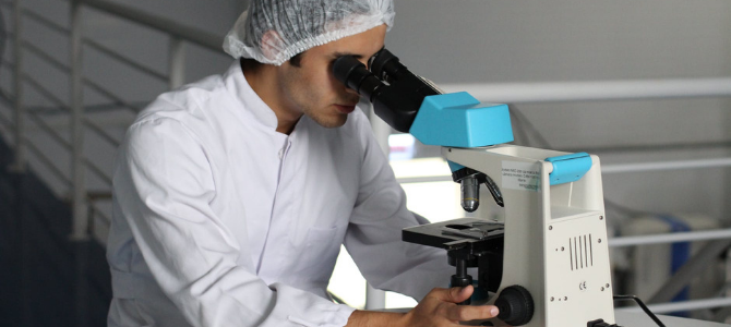 Man in laboratory with microscope