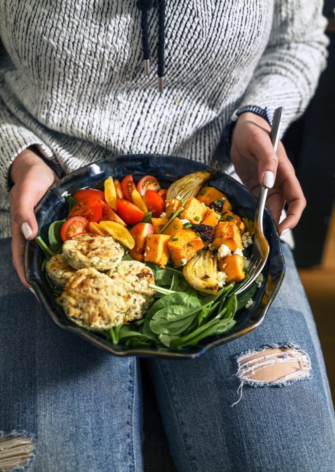 woman holding plate with salad