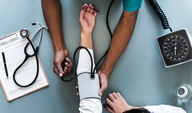 doctor with blood pressure cuff