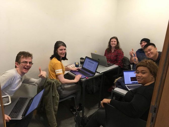Group of college students working with laptops 