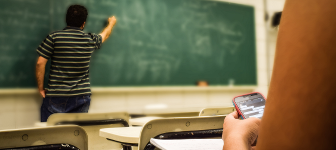 teacher writing on blackboard