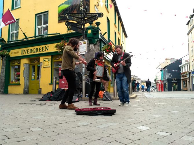 Street performers dancing and playing instruments 