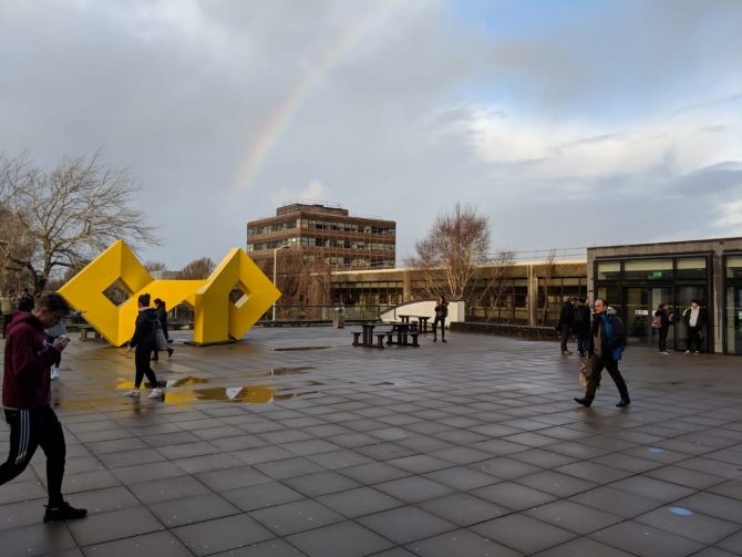 College campus with puddles of water on the ground 