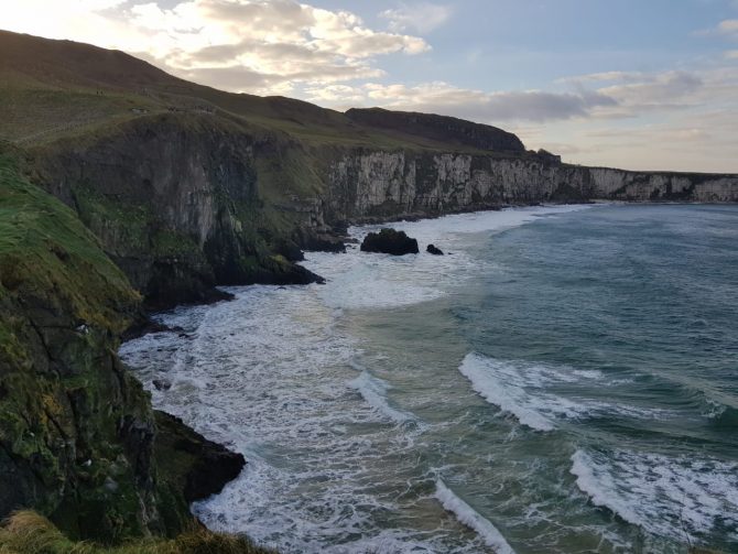 Cliffs and beach with waves rolling in 