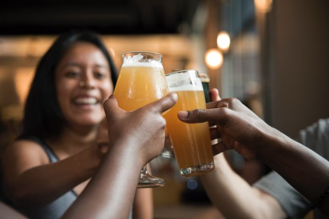 students celebrating with beer