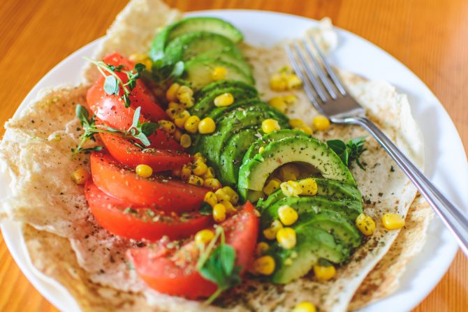 Avocado, tomato and sweetcorn kernels on a plate 