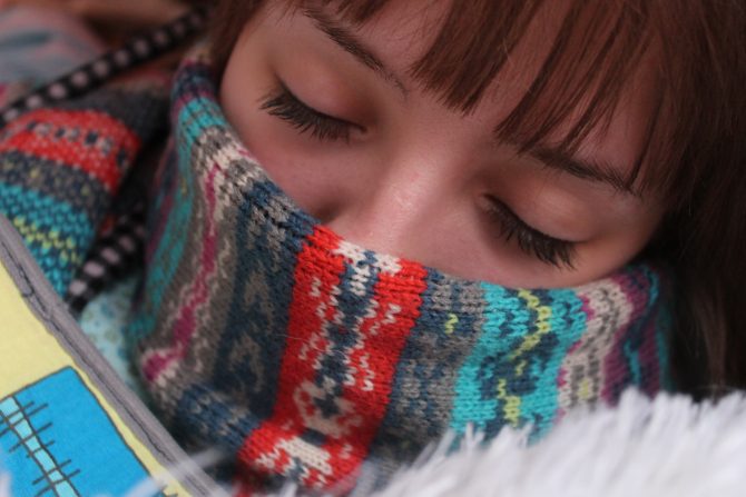 woman with scarf covering her mouth 