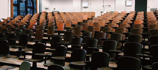 tiered wooden seating in a lecture hall