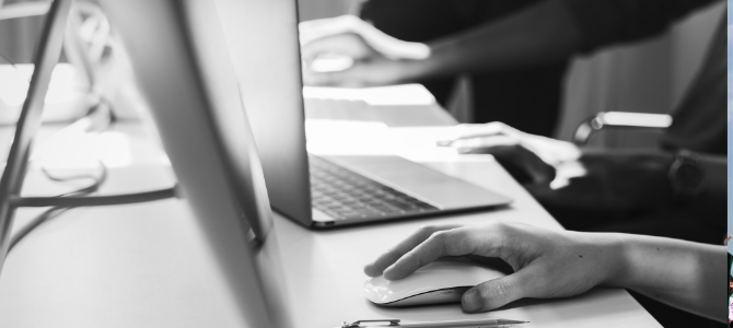 black and white photo of hands typing on a laptop computer